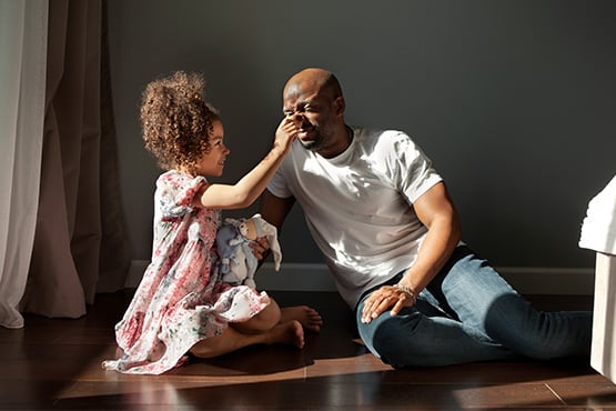 before consulting Gate City Insurance Agency, a dad thinks, how much life insurance do I need, as his daughter grabs his nose