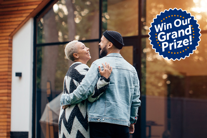 Couple outside new home in Fargo, North Dakota after winning a prize from Gate City Bank during the Fall Parade of Homes.