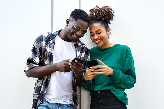 Two people exchange funds through a digital payment app on their phones in Fargo, ND.