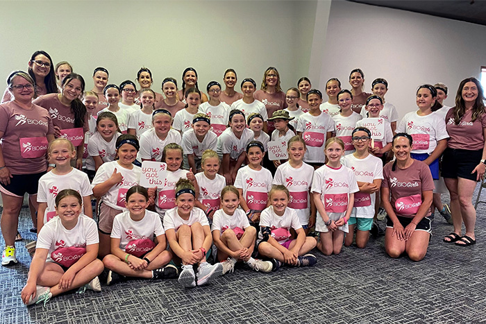 Gate City Bank team member Antoinette Sailor poses with a large group of BIO Girls and their mentors in Devils Lake, ND