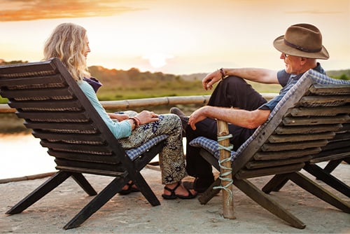 Senior couple relaxing at sunset by their lake home, purchased with a Gate City Bank mortgage loan in Alexandria, Minnesota