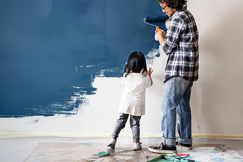 Father and daughter painting their house after getting a home equity loan from Gate City Bank in St. Cloud, Minnesota