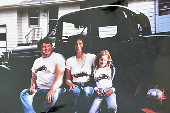 Young Kim Settel and her parents, Jeff and Sheryl Jones, happily pose in front of their restored 1932 Ford Deuce Coupe