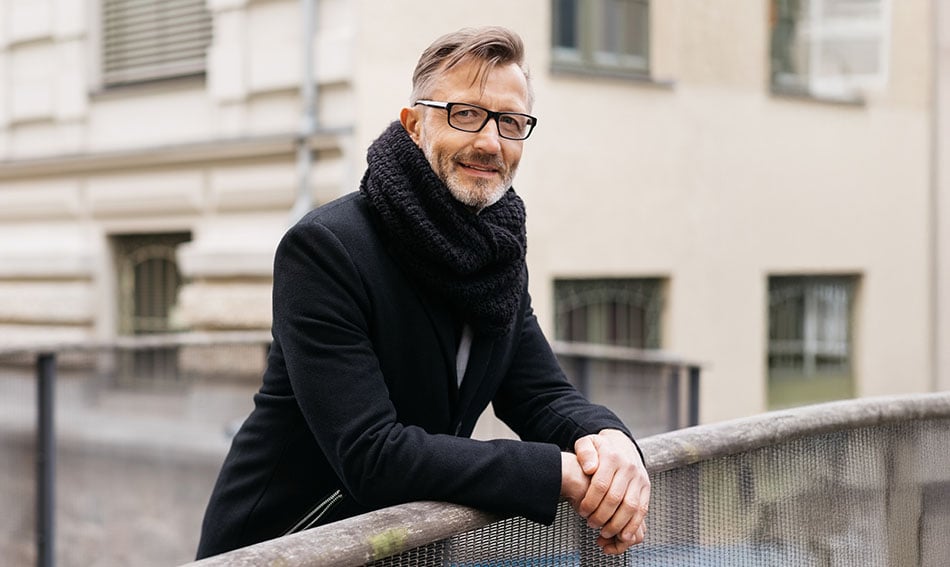 Cheerful senior business owner, walking to meet his business banker in downtown Grand Forks on a chilly winter day 