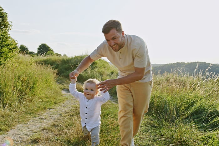 A little boy and his father play at a park in rural Minnesota after visiting their local Gate City Bank.