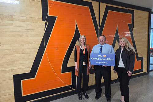 A Gate City Bank team member presents a donation from the My School Spirit program to Moorhead High School in Moorhead, MN.