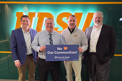 A Gate City Bank team member presents a donation from the My School Spirit program to NDSU in Fargo, ND.