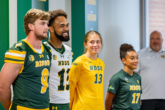 NDSU student athletes sport jerseys with the Gate City Bank logo at a press conference announcing the bank as the first all-sport jersey patch partner of NDSU Athletics.